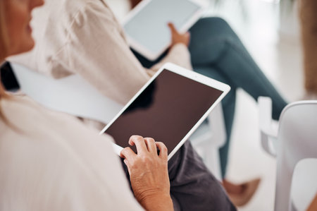 Technology has become so important in everything we do. Closeup shot of an unrecognisable businesswoman using a digital tablet in an office.の写真素材