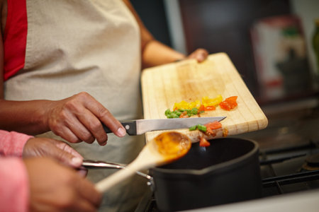 Deliciousness in the making. Closeup shot of two people cooking a meal together at home.