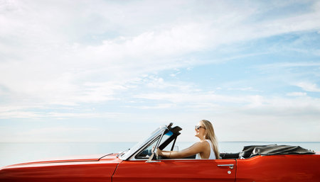 Good weather calls for a good ride. a happy young woman enjoying a summers road trip.