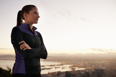 Getting psyched for her run. Shot a beautiful young woman training outdoors.の写真素材