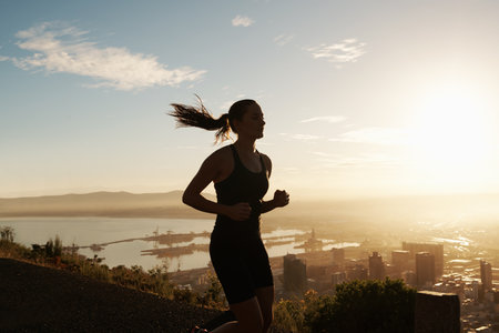 Nothing beats a sunrise run. a young runner training outdoors.の写真素材
