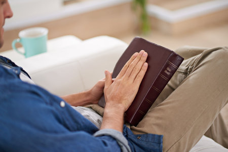 Faith matters. a man reading the Bible at home.