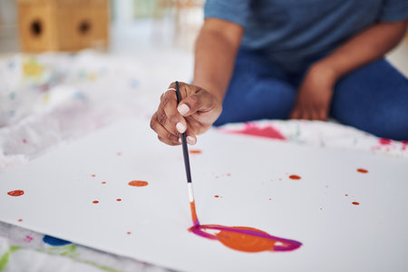 All you need is a splash of color. an unrecognizable woman painting in a art studio.の写真素材