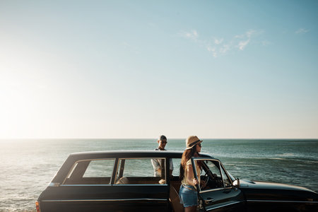 Summer isnt complete without a trip to the ocean. a young couple enjoying a road trip along the coast.の写真素材