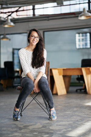 Success is what I work for. Portrait of an attractive young woman sitting in an office.の写真素材