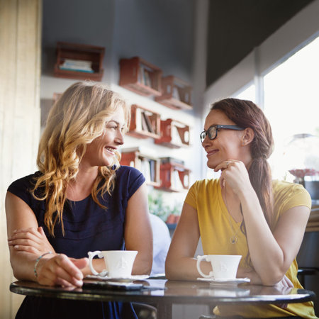 Catching up over coffee. girlfriends in a coffee shop.の写真素材