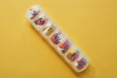 Medicinal support from Monday to Sunday. Studio shot of tablets in a medicine organizer against a...