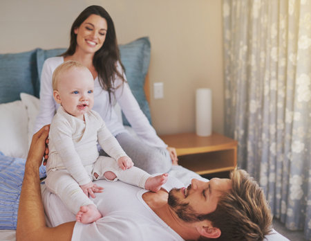 Happy mother, father and fun with baby in bedroom for love, care and quality time to relax together...