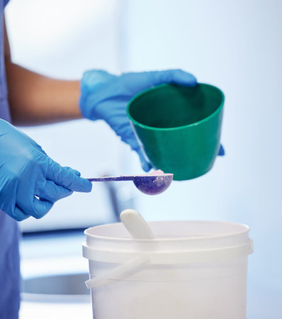 Dental impression prep. an unrecognisable dentist preparing plaster to make a mould during a dental...
