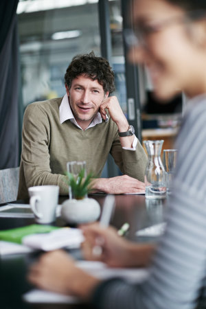 This meeting is inspiring. a coworkers in a business meeting.の写真素材