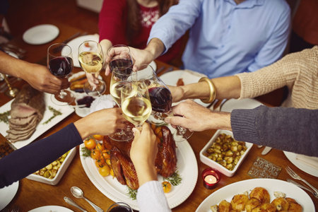 Special moments with special people. Closeup shot of a group of people making a toast at a dining table.の写真素材