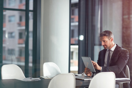 Tablet, typing and business man planning in office, conference room or glass reflection, data analysis and software. Professional person or corporate office CEO search analytics on digital technologyの写真素材