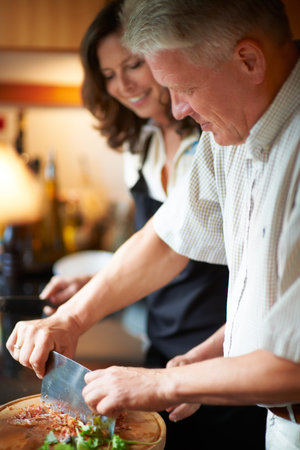 Creative cooking. a senior couple cooking in the kitchen.