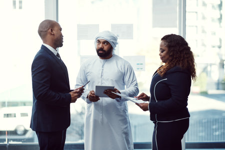 Making sure everyone understands. a group of diverse business colleagues working together in their corporate office.の写真素材