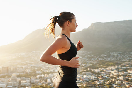Running, fitness and woman with balance, exercise and cardio with healthy lifestyle, wellness and workout. Female person, runner and athlete outdoor, view and target with performance, goal and sportsの写真素材
