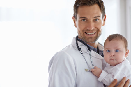 Portrait, happy man and pediatrician with baby on mockup for medical assessment, support and healthcare of children. Newborn kids, doctor and smile in pediatrics clinic, hospital and trust in serviceの写真素材