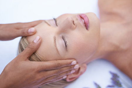 Relax, beauty and face massage, woman in spa for health, wellness and luxury treatment with eyes closed. Salon facial, hands and professional skin care therapist with healthy girl in skincare routineの写真素材