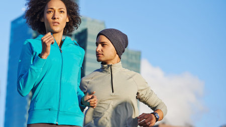 She takes the lead. two friends out jogging in the city.