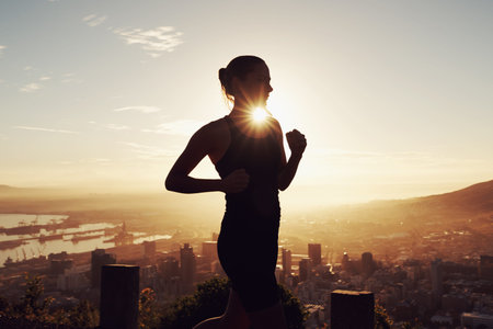 Greeting the sun with an early morning run. a young runner training outdoors.