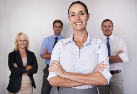 Portrait, happy woman and leadership of team, white background and isolated studio for professional...
