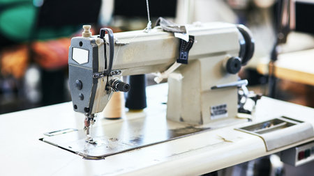 The machine that puts everything together. Closeup show of a sewing machine in a workshop.の写真素材