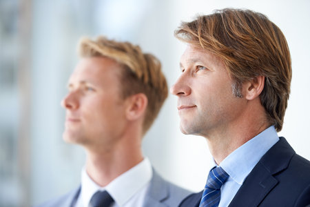 Looking towards the future. Two businessmen looking away into the distance.の写真素材