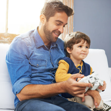 Love, father and son with video game, happiness and gaming at home, loving or smile. Family, male...
