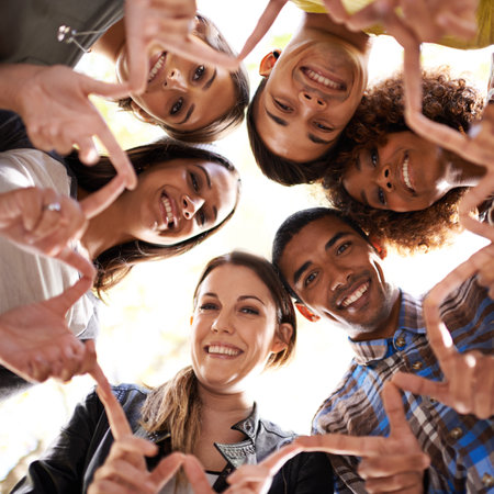 Finger star, circle and portrait of friends with diversity, unity and collaboration with a low angle. Teamwork, smile and group of multiracial people in huddle together for solidarity and community.の写真素材
