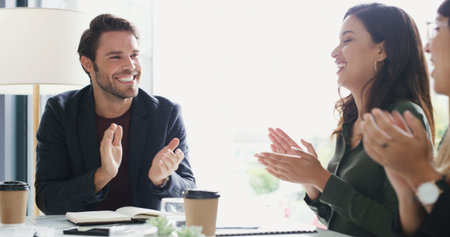 Were going to keep growing and succeeding together. a group of businesspeople applauding during a...