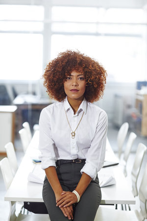 Success breeds confidence. a beautiful young businesswoman in her office.の写真素材
