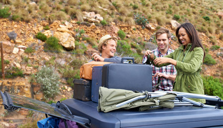Ready to set up camp. A group of young people unloading their luggage on a camping trip.