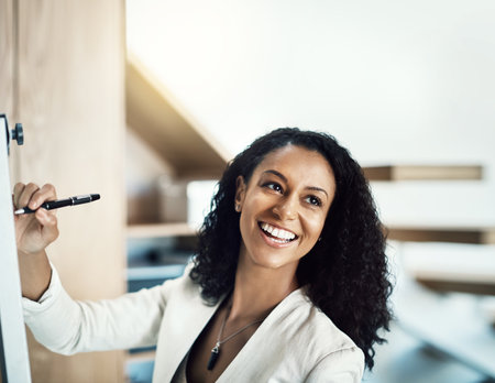 Board, writing and happy business woman planning strategy, office ideas or brainstorming startup plan. Whiteboard, research notes and face of person smile for entrepreneurship development projectの写真素材