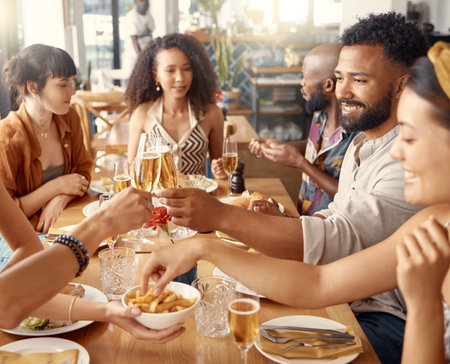 Toasting to a bright new future. a group of friends toasting in restaurant.の写真素材