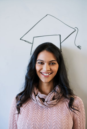 Im almost there. Cropped portrait of a young university student standing against a whiteboard with a...