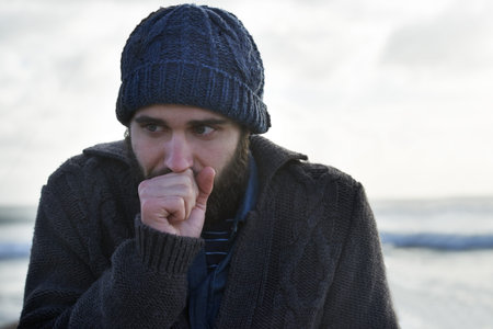 Its a cold morning...Portrait of a young man standing in a winter landscape.