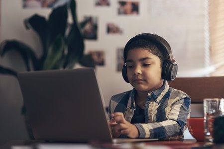 Wireless tech gave us an easier way of learning. an adorable little boy using a laptop and...