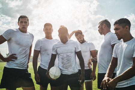 The world better watch out us. Portrait of a group of cheerful young rugby players celebrating their win after a match outside during the day.の写真素材