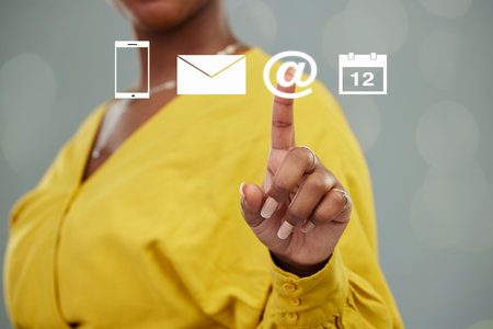 Woman, hands and hologram icons for email, global communication or social media in contact us. Hand of female person touching holographic icon of futuristic hud in networking or interactive dashboardの写真素材