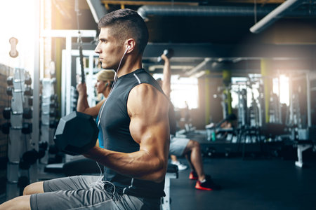 Give it all youve got. a man doing a upper-body workout at the gym.