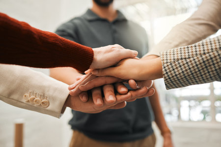 Group of businesspeople with hands stacked. Corporate professionals giving each other motivation....
