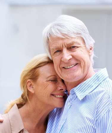 Theres nothing like growing old with someone. Close up of an elderly couple standing outdoors.の写真素材