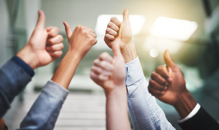 Thumbs up, winner and support with hands of business people in office for agreement, yes and teamwork like. Emoji, success and community with group of employees for goals, thank you and motivationの写真素材