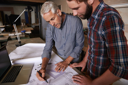 Architect men, teamwork and drawing blueprint with discussion, construction goal or vision in...