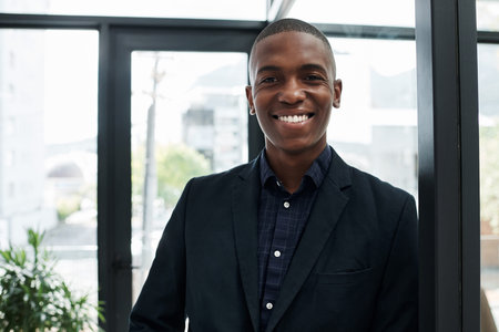 His mindset is right on the money. Portrait of a confident young businessman working in a modern...