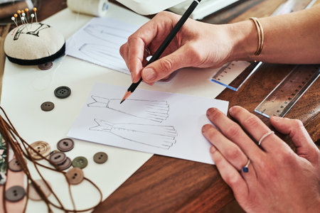 The meaning of life is to find your gift. a fashion designer working on new sketches at her desk.の写真素材
