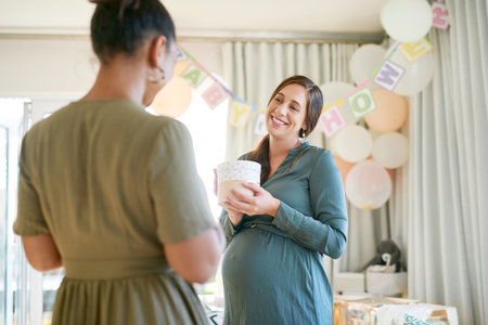 Thank you so much. a woman giving her friend a gift at her baby shower.の写真素材