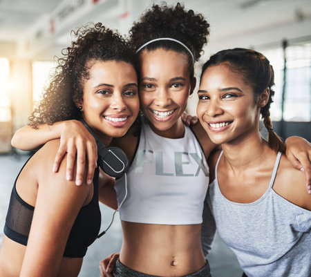 Keep your friends close and keep those spirits lifted. a group of happy young women enjoying their time together at the gym.の写真素材
