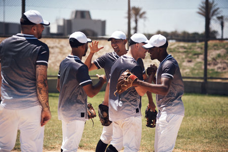 Baseball team mates are our second brothers. a group of young baseball players celebrating after playing a game.の写真素材