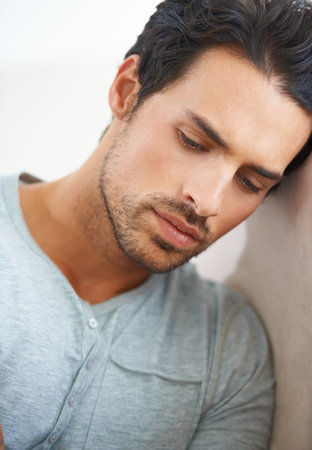 Dreamy good looks. a handsome young man looking thoughtful.の写真素材