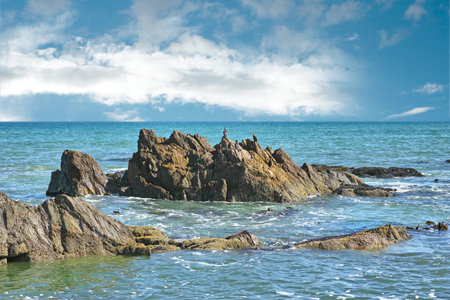 Coastal view of a tranquil sea. A calm ocean on a sunny day seen from a rocky coastline.